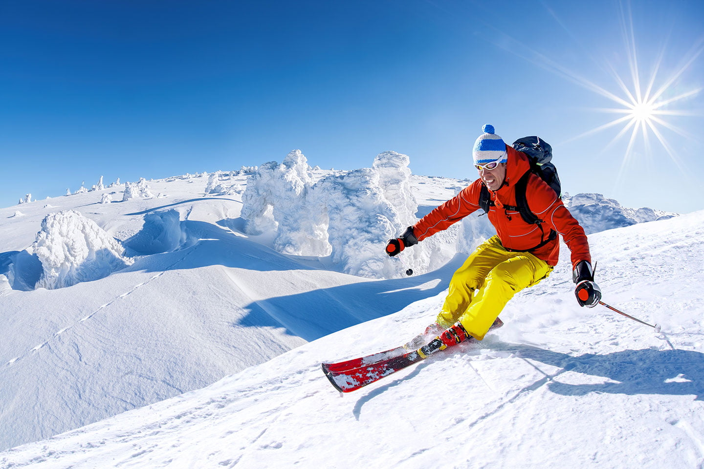 A totally unrelated picture of a man skiing down a mountain really really fast. He has red skis on, with yellow pants and an orange jacket. He is wearing a blue and white toque with a pom-pom on top. He likely has one of those bitchin' rescue backpacks on that inflate and keep you alive in case there's an avalanche. This kind of experience cost way more than what the boys got for their gems, but I wonder if it involved "snow" in some way...